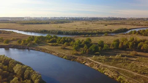Panoramic top view of river, autumn landscape and city on horizon Stock Footage 98847552