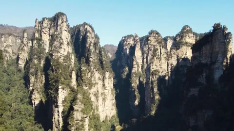 Panoramic towering sandstone pillars in a lush mountain forest landscape Video stock 342090842