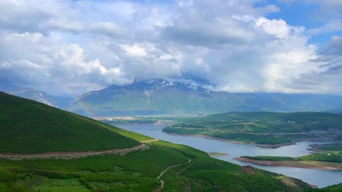 Panoramic valley with river, cloudy sky and green mountain hills Stock Footage 310246170