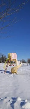 Panoramic vertical web banner of the Slide - play equipment covered with snow Stock Photos
