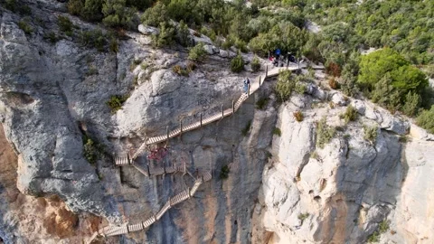 Panoramic vertiginous impressive aerial view of wooden staircase at rock cliff Video stock 242035879