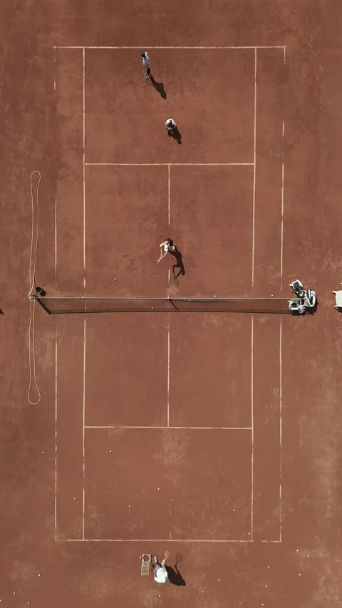 A panoramic view from above captures a tennis training session. The players on Stock Footage 247246785