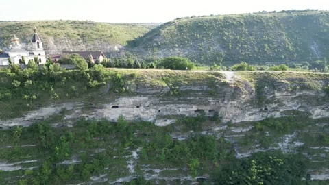 Panoramic view from above of rugged limestone cliffs framing a river valley Stock Footage 340240280