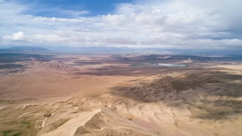 Panoramic view from above on a sandy desert with lakes. Stock Footage 93870673