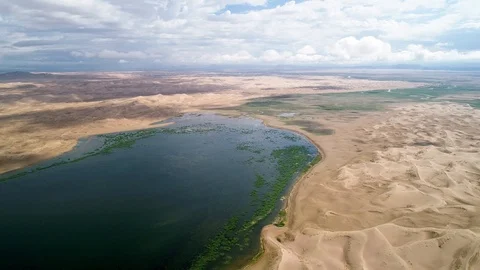 Panoramic view from above on a sandy desert with lakes. Stock Footage 93870709