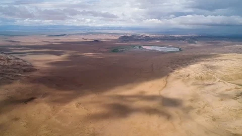 Panoramic view from above on a sandy desert with lakes. Stock Footage 93870750