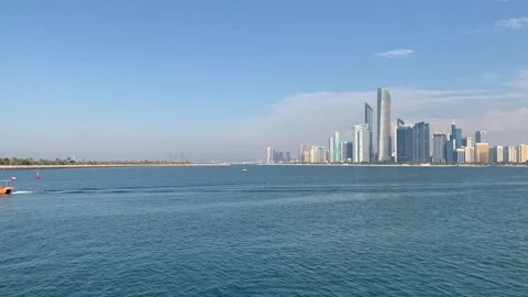 Panoramic view of Abu Dhabi city skyline. Traditional abra boat. Abu Dhabi, UAE Stock Footage 298914359