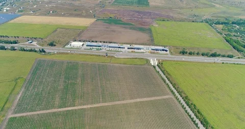 Panoramic view from the air to agricultural fields and highways. The agrarian 動画素材 92795808