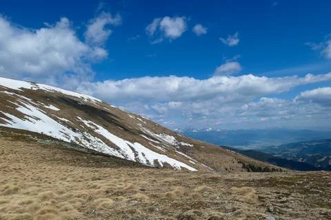 A panoramic view on an Alpine chain in Austria, partially covered with snow.. Stock Photos
