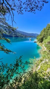 Panoramic view of alpine landscape seen from east bank of lake Weissensee i.. Stock Photos