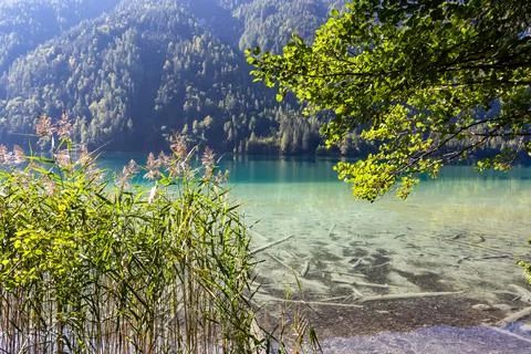 Panoramic view of alpine landscape seen from east bank of lake Weissensee i.. Stock Photos
