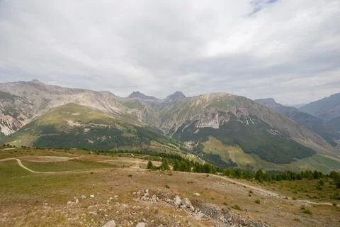 Panoramic View of Alpine Valley and Dirt Path Stock Photos