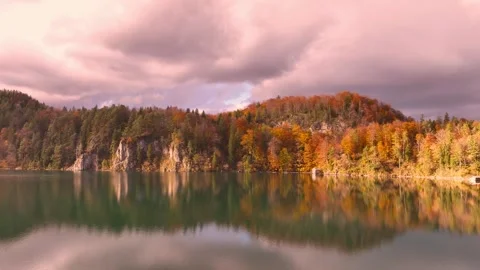 Panoramic view with the Alpsee lake as reflection in Autumn trees season Stock Footage 258750646