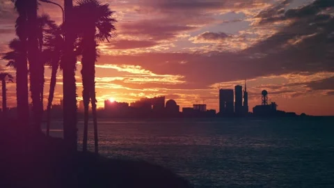 Panoramic view of amazing orange sunset over silhouettes of resort city high Stock Footage 261590403