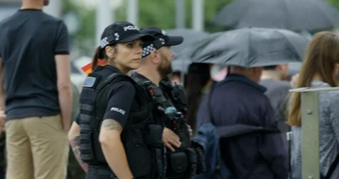 Panoramic View Of Armed Police At Parade With Rainbow Flags Umbrellas and Signs Stock Footage 113518916