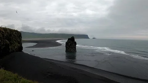 Panoramic view of Arnardrangur sea stack and Reynisfjara beach, Iceland Stock Footage 334679723