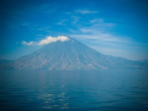 Panoramic view to Atitlan volcano and lake with smoke, Guatemala Stock Photos