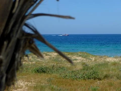 Panoramic view from the beach of a passenger ship sailing Stock Photos
