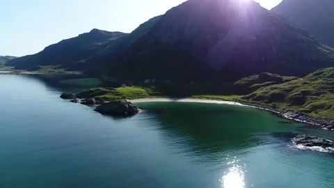 Panoramic view of the beautiful beach at the foot of green mountains Stock Footage 136847688