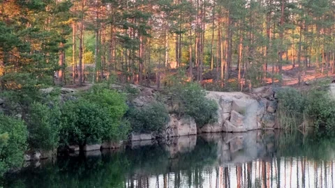 Panoramic view of a beautiful clear lake among granite rocks and a pine forest Stock-Footage 145720474