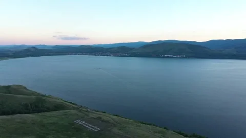 Panoramic view of beautiful lake surrounded by Ural mountains on a sunset 스톡 동영상 254348650