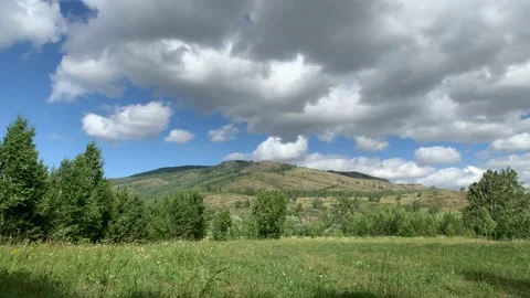 Panoramic view. Beautiful summer landscape. Mountains, blue sky and green fields Stock-Footage 133833415
