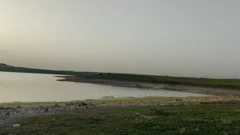 Panoramic view of beautiful sunset over the lake in spring. Видео 241367272