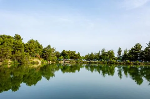 Panoramic view of Beletsi Lake with forest reflection in Attica, Greece. Stock Photos