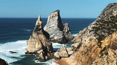 Panoramic view of big waves breaking on rocky shore and white foam on water Stock-Footage 127448328