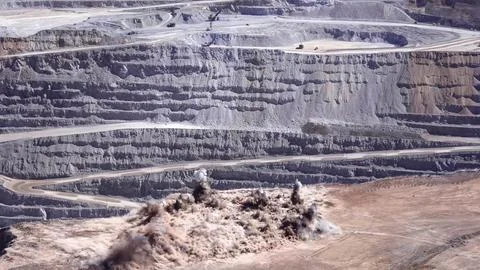 Panoramic view of the blasting process in an open pit mine Stock Photos