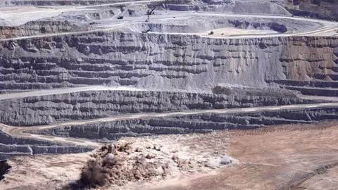 Panoramic view of the blasting process in an open pit mine Stock Photos