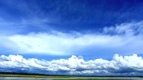 Panoramic View of Blue Sky with Cumulus Clouds over a Calm Body of Water Stock Footage 310818269