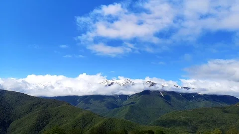 Panoramic view of the blue sky, white clouds and mountains Stock Footage