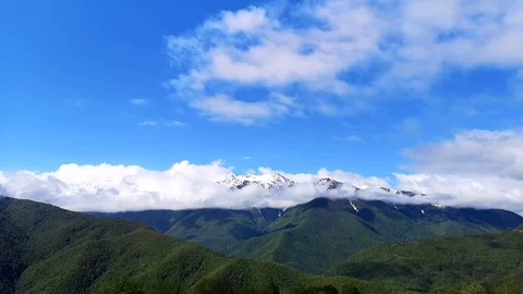 Panoramic view of the blue sky, white clouds and mountains Stock Footage 109338289