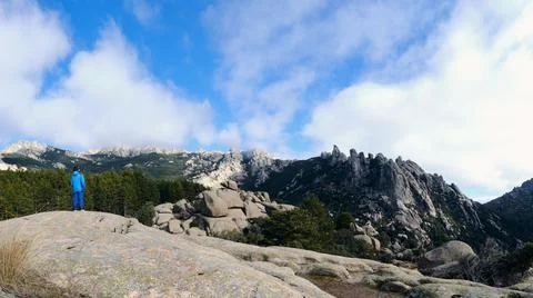Panoramic view of a boy observing the mountains in the Pedriza Regional Park. Stock Photos