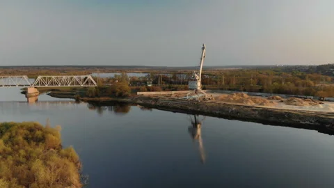 Panoramic view of the bridge over the river and the tower crane, which is Stock Footage 112500232