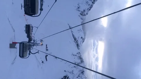 Panoramic view of the cable car between the snow-capped mountain peaks. Stock Footage 123307800