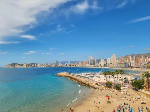 Panoramic view Cala de Mal Pas beach and skyline with tourists, Benidorm, Spain Stock Photos
