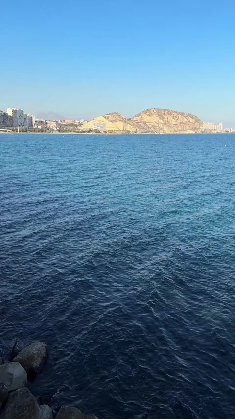Panoramic view of calm blue sea with distant rocky hills in Alicante Stock Footage 294821319