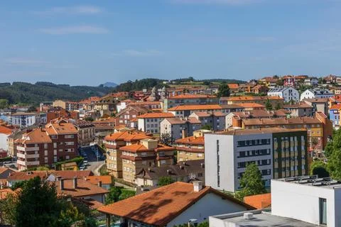 Panoramic view of Candas town red rooftops and green hills Asturias Spain Stock Photos
