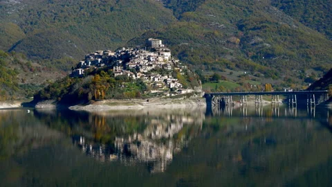 Panoramic view of Castel di Tora reflected in the water of the Turano lake Stock Footage 146482252