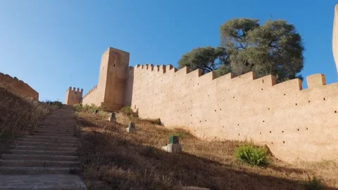 Panoramic view of Chellah's outer walls in Rabat, surrounded by greenery, Video stock 252360122