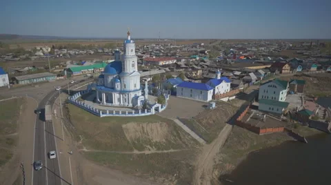 Panoramic view of church standing next to road in middle of village Stock Footage 67171815