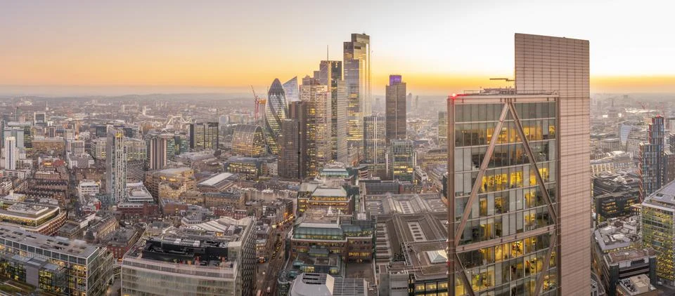Panoramic view of City of London skyscrapers and Tower Bridge at dusk from the Stock Photos