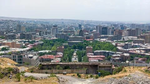 Panoramic view of cityscape featuring dense urban development and green spaces 写真素材