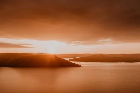 Panoramic view from the cliff to the big river lake sea in the distance silho Stock Photos