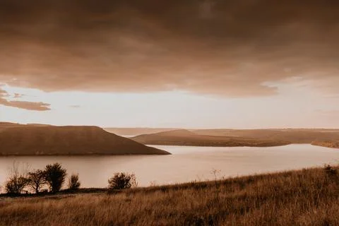 Panoramic view from the cliff to the big river lake sea in the distance silho Stock Photos