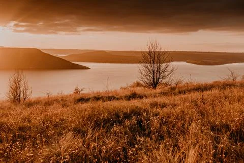 Panoramic view from the cliff to the big river lake sea in the distance silho Stock Photos