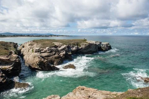 Panoramic view from a cliff over a rugged coastline. Stock Photos