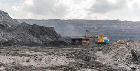 Panoramic view of coal mine. Open pit mine industry, big yellow mining truck for Photos